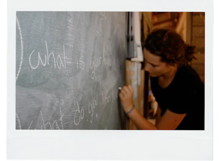picture of me drawing on a blackboard in Thailand